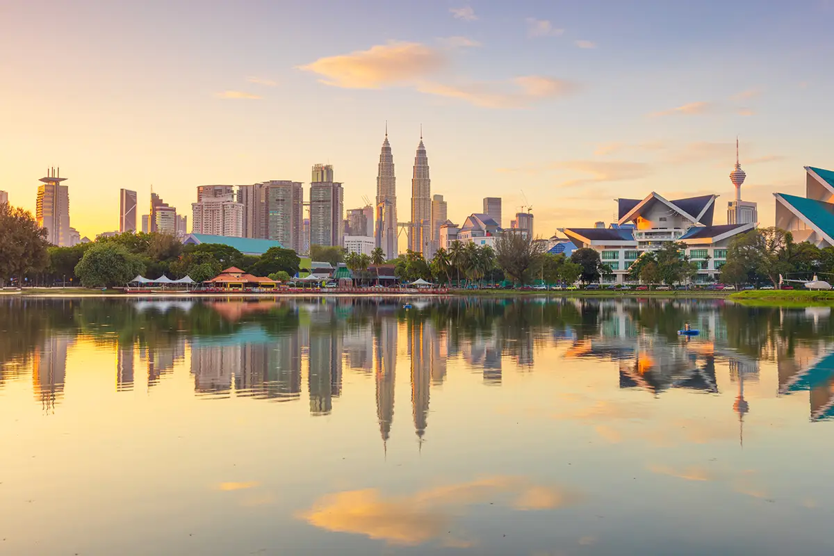 Beautiful view of Kuala Lumpur skyline at sunset, reflected in the calm waters of Titiwangsa Lake