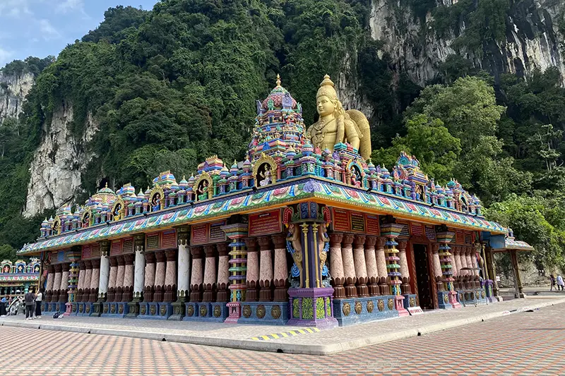 Vibrant temple and golden Lord Murugan statue at Batu Caves, a must-visit attraction on a Kuala Lumpur city tour.