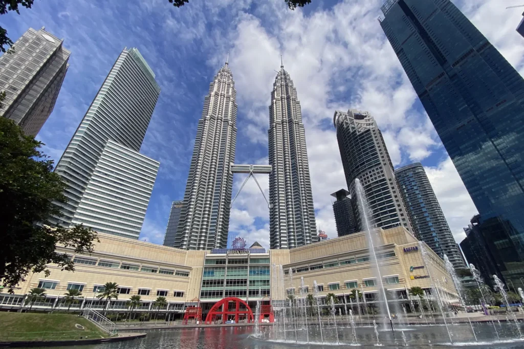 Petronas Twin Towers viewed from KLCC Park with fountains in the foreground, a highlight of Kuala Lumpur city tours.
