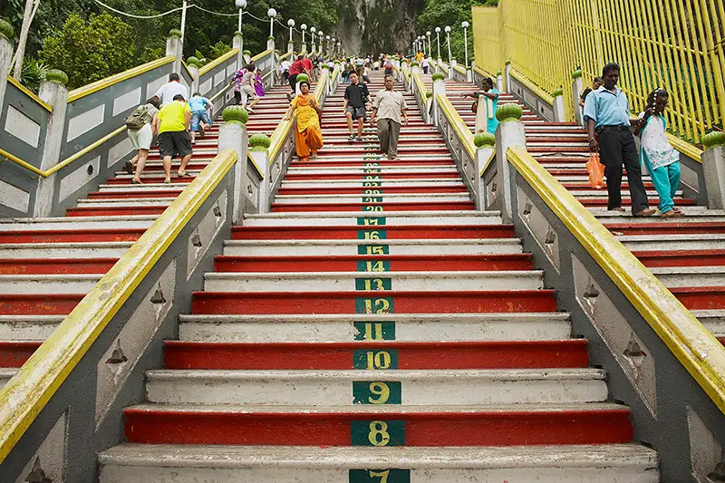 Old photo of Batu Caves staircase from 2009 showing red and white painted steps with numbered markings and only three stair lanes.