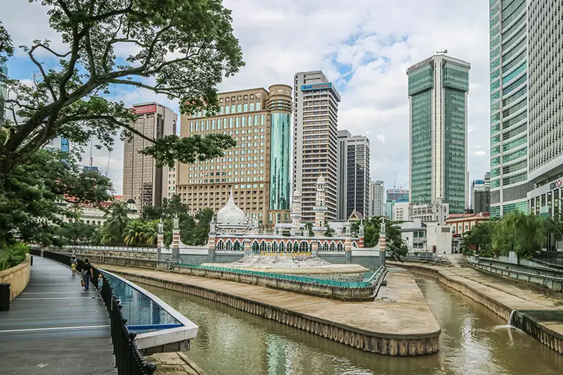 Scenic view of Kuala Lumpur’s River of Life with Jamek Mosque in the background, ideal stop during 2 days in Kuala Lumpur