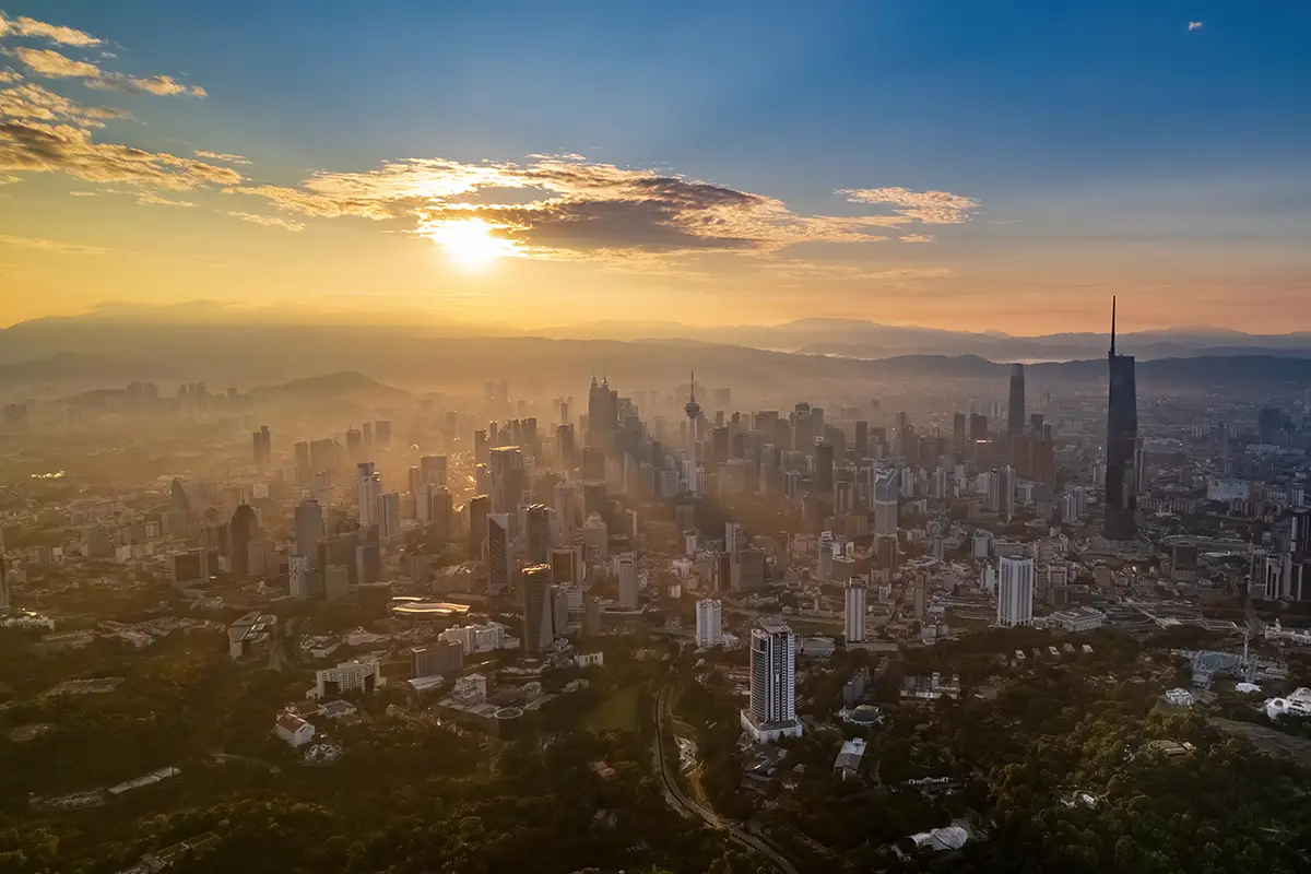 Aerial view of Kuala Lumpur city skyline at sunrise with KL Tower and Merdeka 118, perfect for planning a Kuala Lumpur 2 days itinerary